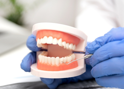 What is the difference between dental implants and dentures?